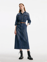 a lady in maxi denim dress with black boots